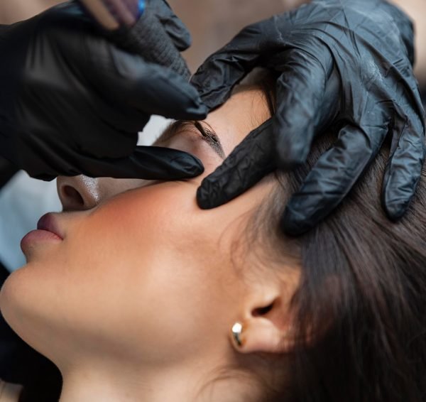 young-woman-getting-beauty-treatment-her-eyebrows